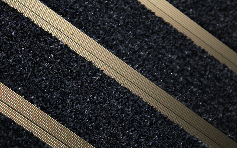 Close up image of Black Granati inserts in Bronze ARCHIMAT aluminium architectural matting