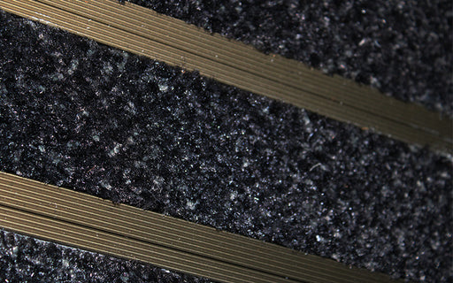 Close up image of Black Reno inserts in Bronze ARCHIMAT aluminium architectural matting
