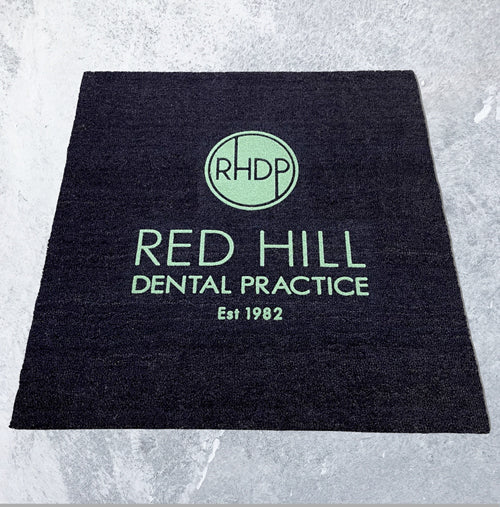 Full product image of black coir base with green embossed logo.