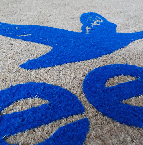 Close up image of grey coir with blue embossed logo.
