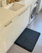 Insitu image of a tough comfort standing desk mat in home laundry used to relieve body aches from standing for long periods