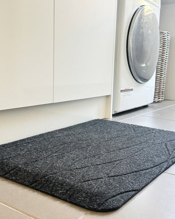 insitu image of black tough comfort standing mat in a laundry