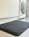 insitu image of black tough comfort standing mat in a laundry