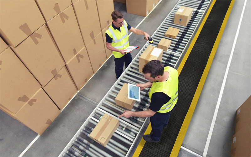 Insitu image of Anti-fatigue mat called Diamond Foam Mat in black with yellow safety edges at an assembly production line
