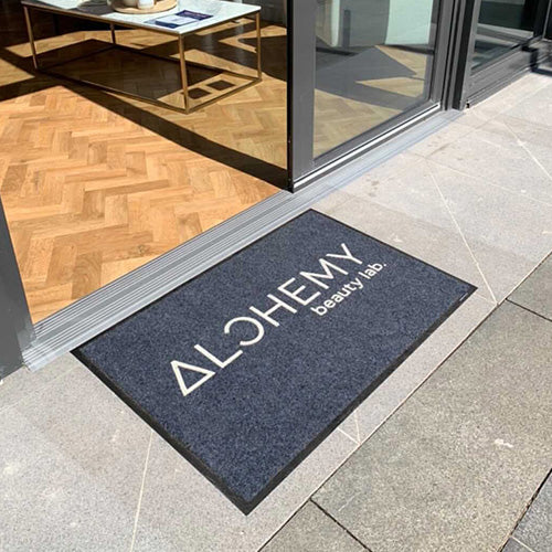 Insitu product image of charcoal Dirtstopper Logo Mat with one colour print at beauty salon entrance