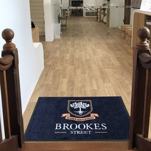 Insitu product image of PrintPlush Logo Mat at the base of stairs at a early education facility