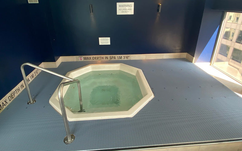 Product image of grey, PVC Safety Grip Tubular installed around a spa bath