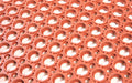 Close up of the drainage hole pattern of the nitrile rubber safewalk mat in terracotta