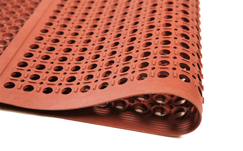 Corner image of the drainage holes in the nitrile terracotta safewalk mat