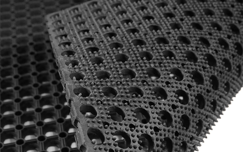 Close up of the raised studded backing on the rubber honeycomb heavy duty drainage mat.