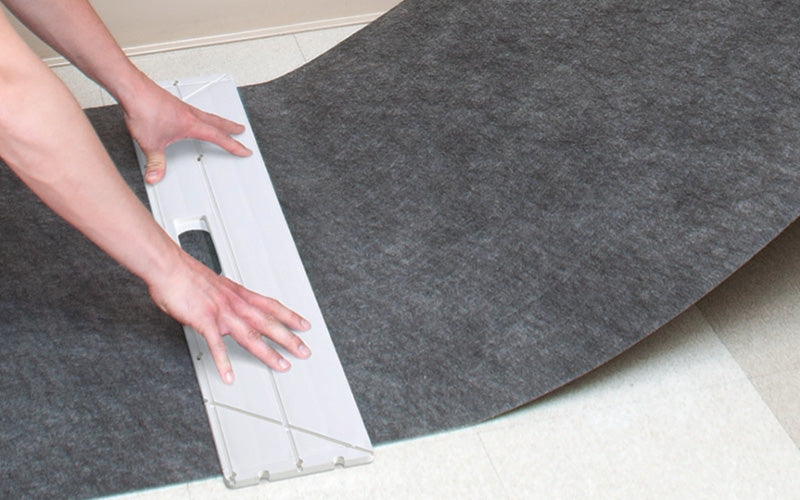 Insitu picture of the SmartGrip Safey Knife and Cutting tool being used to measure the Smart Grip Mat.