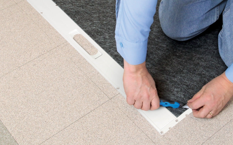Insitu picture of the Safety Cutting tool being used on the SmartGrip Roll Mat.